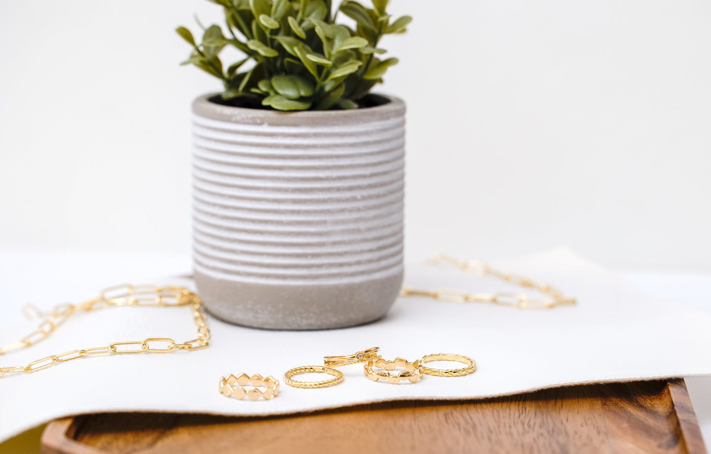 Variety of 5 different gold rings shown. 