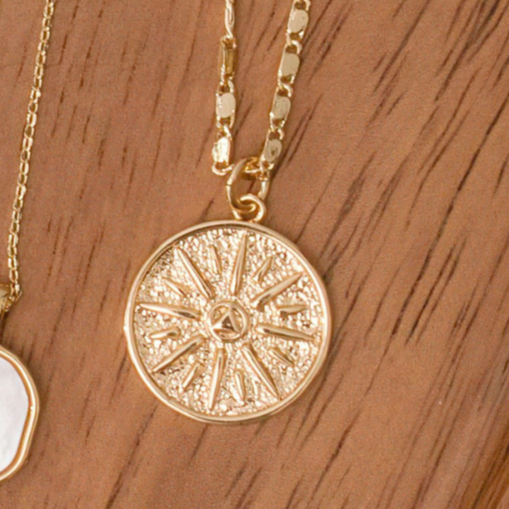 Gold necklace with 18" unique chain and gold coin compass pendant.